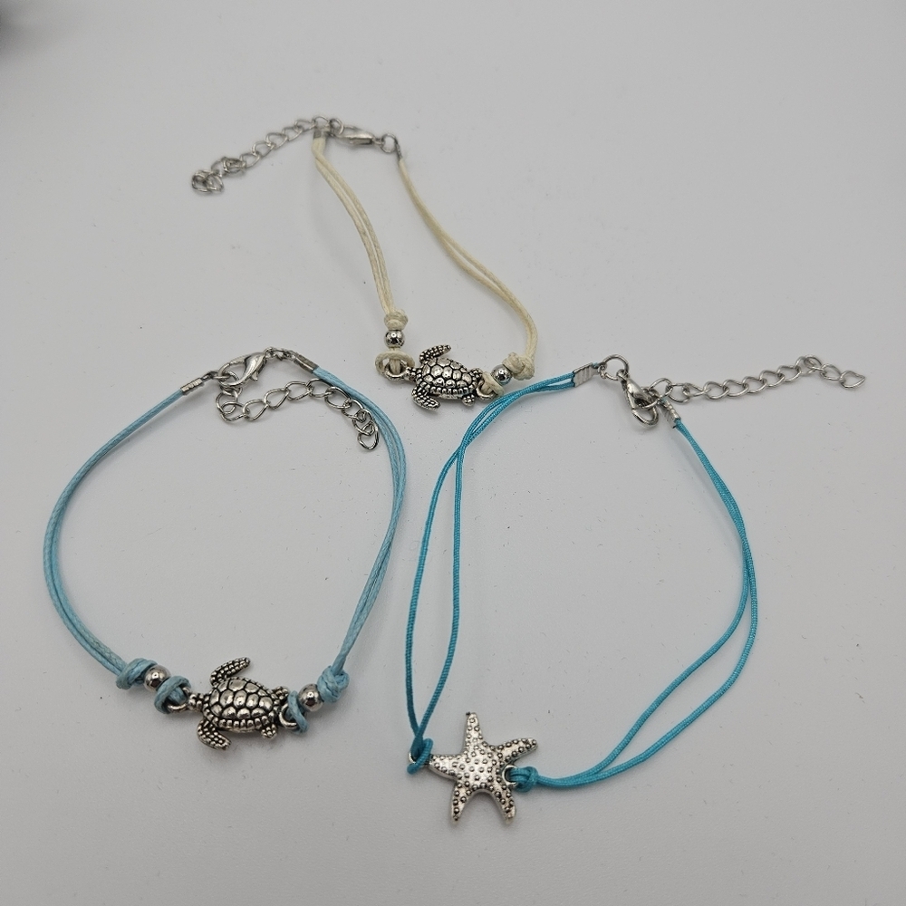 trio of fabric cord bracelets with silver tone marine beach charms